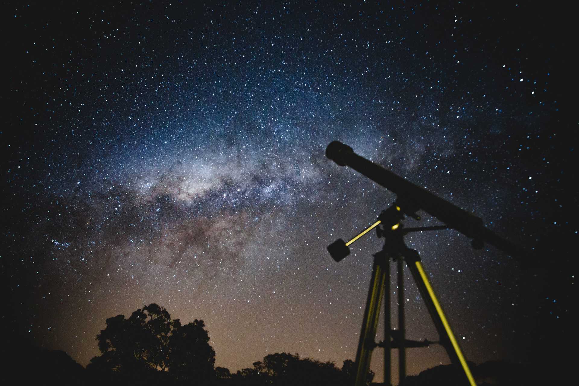 Telescope in the foreground, space in the background